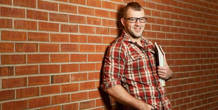 guy by brick wall